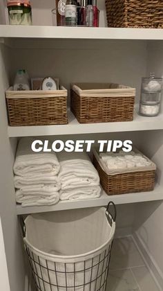 an organized closet with baskets, towels and other items on shelves next to a laundry basket