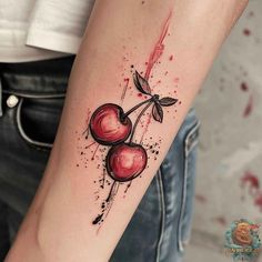 a watercolor style cherry tattoo on the arm