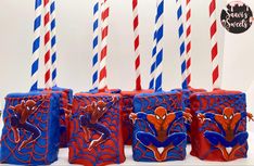 spiderman themed birthday candles with red, white and blue striped straws in the background