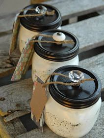 three mason jars sitting on top of a wooden bench