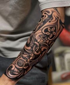 a man with a black and grey tattoo on his arm