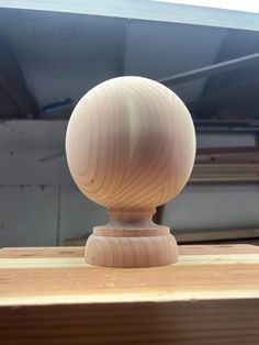 a wooden object sitting on top of a table next to a piece of plywood