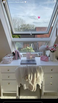 a white desk topped with a laptop computer next to a window