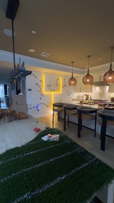 a living room filled with lots of furniture and lights on top of the tables in front of them