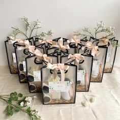 four clear vases with flowers in them on a table