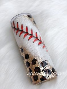 a baseball themed lighter with red stitching on it