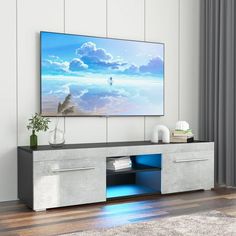 a flat screen tv sitting on top of a entertainment center