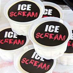 four ice cream containers with the words ice cream written on them are sitting on a table