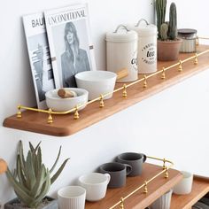 the shelves are filled with cups and bowls