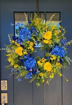 a blue and yellow wreath on the front door