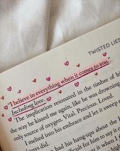 a piece of paper that has writing on it with pink hearts in the corner and two lines between them