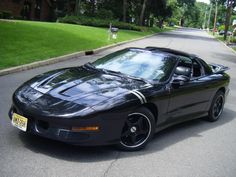 a black sports car is parked on the street