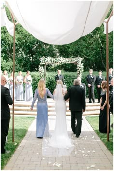 the bride and groom are walking down the aisle