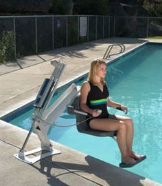 a woman sitting on a chair next to a pool with a wheelchair attached to it