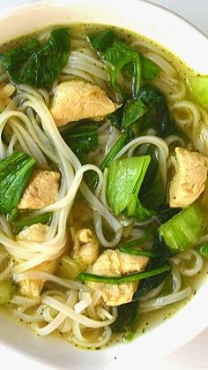 a white bowl filled with noodles and vegetables