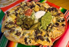 a colorful table cloth with a taco salad on it