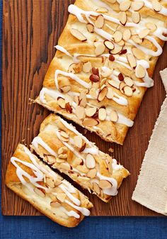 sliced almond bread sitting on top of a wooden cutting board