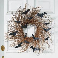 a halloween wreath with bats on the front door