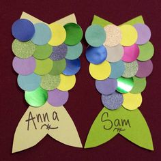 two paper fish made to look like they have been cut out with the words anna and sam on them