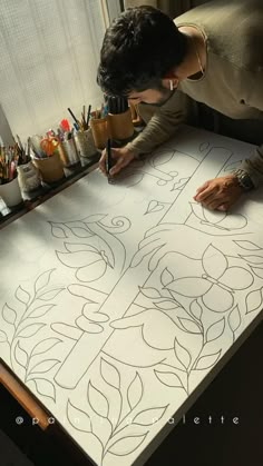 a man is drawing on a piece of paper