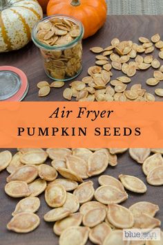 pumpkin seeds on a table with the words air fryer pumpkin seeds in front of them