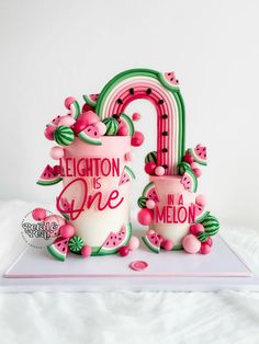 there is a cake made to look like the number one with watermelon on it