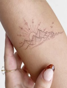 a woman's arm with a small tattoo on the left side of her body