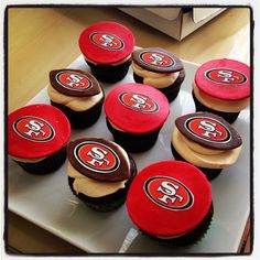 twelve cupcakes with san francisco giants icing on top are arranged in a square pattern