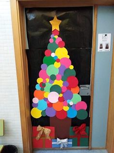 a door decorated with paper circles and a christmas tree