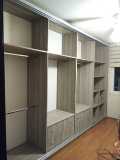 an empty room with some shelves and drawers