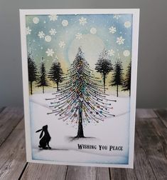 a card with a christmas tree on it and the words wishing you peace written below