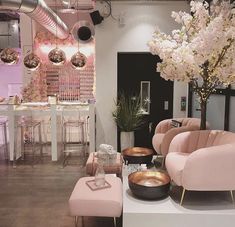 a living room filled with furniture and flowers in vases on top of it's tables