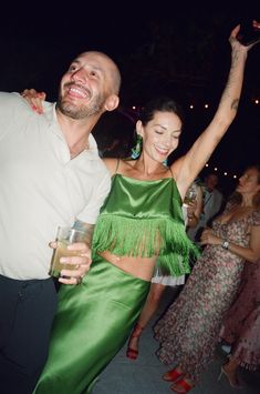 a man and woman dancing at a party