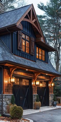 a two car garage with lights on the windows