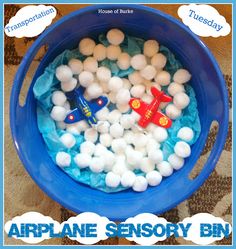 a blue bowl filled with marshmallows and an airplane