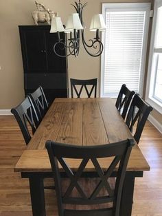 a dining room table with six chairs and a chandelier