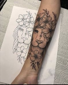 a woman's arm with flowers and a lion tattoo on the left side of her forearm