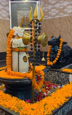 an elaborately decorated fountain with candles and flowers