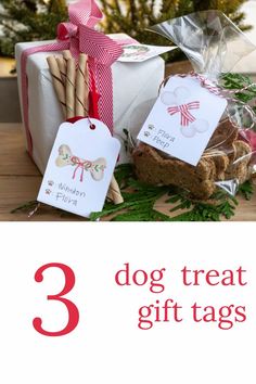 three dog treat gift tags in front of a christmas tree with presents on the table