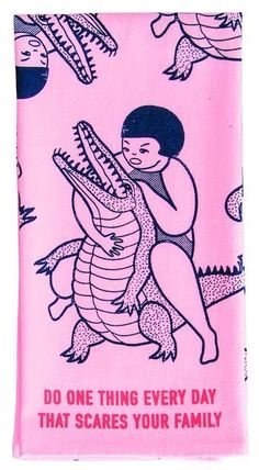 a pink towel with an image of a woman hugging a large alligator on it's back