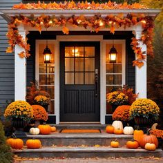 a front porch decorated for fall with pumpkins and gourds