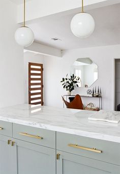 an instagramted photo of a kitchen with white countertops