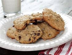 chocolate chip cookies on a plate next to a glass of milk