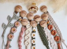 several wooden buttons with names on them and some crocheted yarn around the beads