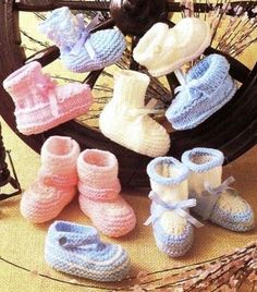 several pairs of baby booties sitting on top of a table next to a wheel