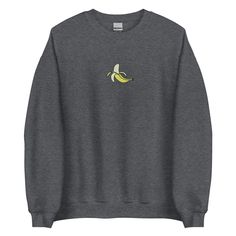 A sturdy and warm sweatshirt bound to keep you warm in the colder months. A pre-shrunk, classic fit sweater that's made with air-jet spun yarn for a soft feel. This peeled banana embroidered sweatshirt is available in 10 colours. * 50% cotton, 50% polyester * Pre-shrunk * Classic fit * 1x1 athletic rib knit collar with spandex * Air-jet spun yarn with a soft feel * Double-needle stitched collar, shoulders, armholes, cuffs, and hem SIZE GUIDE in Inches S              Width 20"     Length 27" M Peeled Banana, Sweater Handmade, Embroidered Sweatshirt, Embroidered Sweatshirts, Fitted Sweater, Crewneck Sweater, Air Jet, Sleeve Sweater, Color Choices