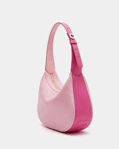 a pink and white purse on a white surface with the handle extended to it's side