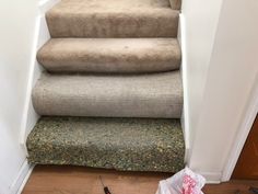 a carpeted stair case next to a pair of scissors