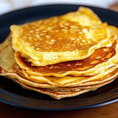 stack of pancakes sitting on top of a black plate