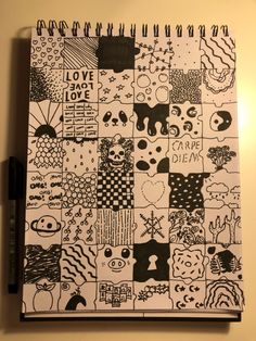 a notebook covered in black and white doodles